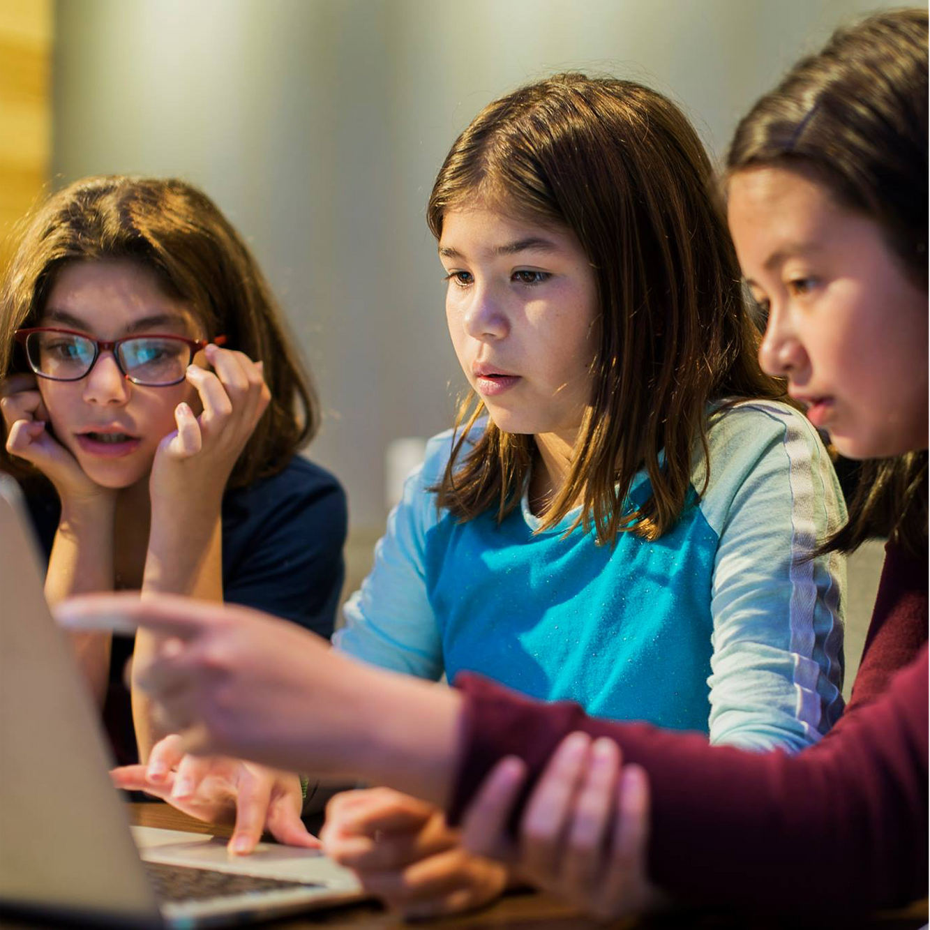 three girls looking at computer