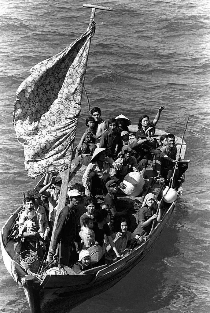 35 Vietnamese refugees wait to be rescued from a 35 foot fishing boat 350 miles northeast of Cam Ranh Bay, Vietnam, after spending eight days at sea. Public Domain.