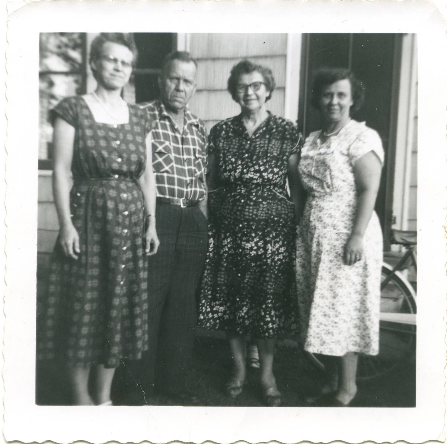 4 adults standing and dressed in formal clothes