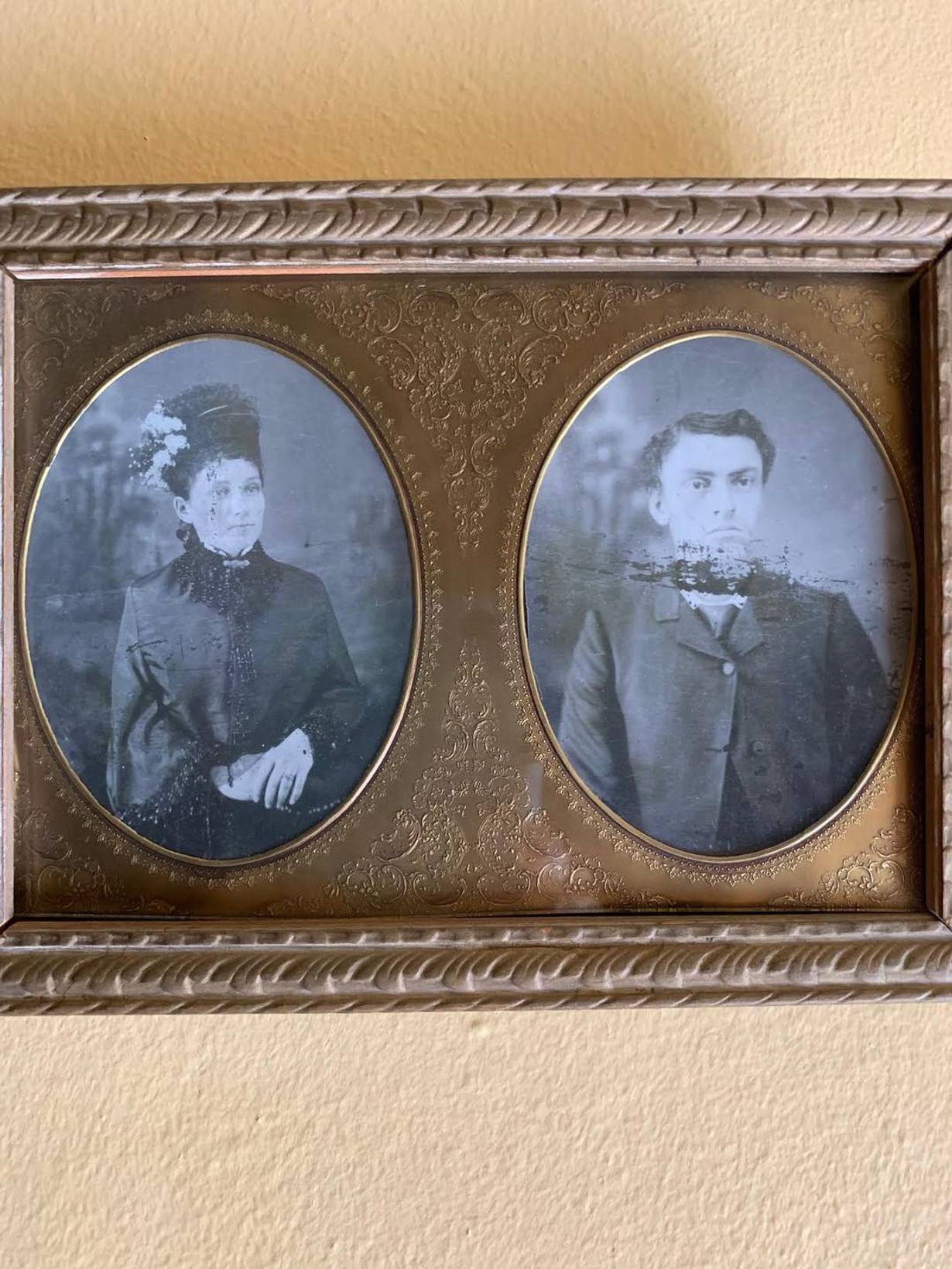 Old photograph of man and woman dressed in bronze picture frame