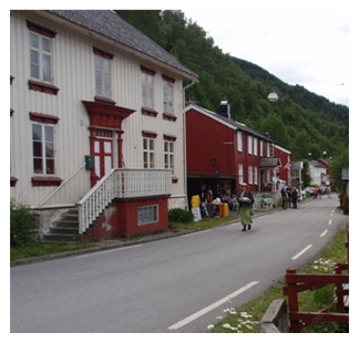 Red and white buildings alongside a road