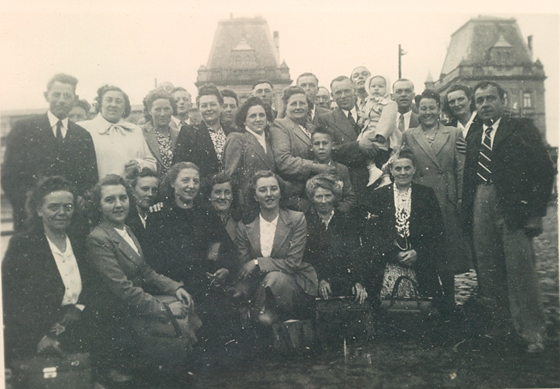 Large gathering of family members crouched down and smiling