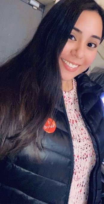 Woman in black jacket with a I voted sticker