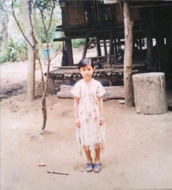 Girl standing outside of a house wearing a white dress