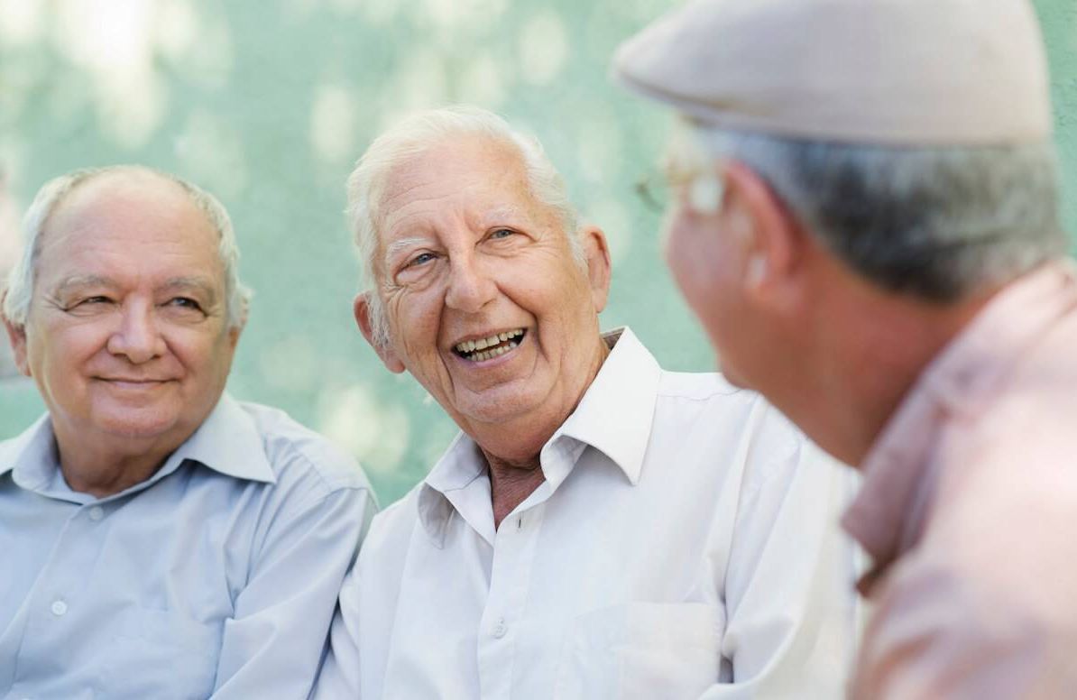 Group of happy elderly men laughing and talking