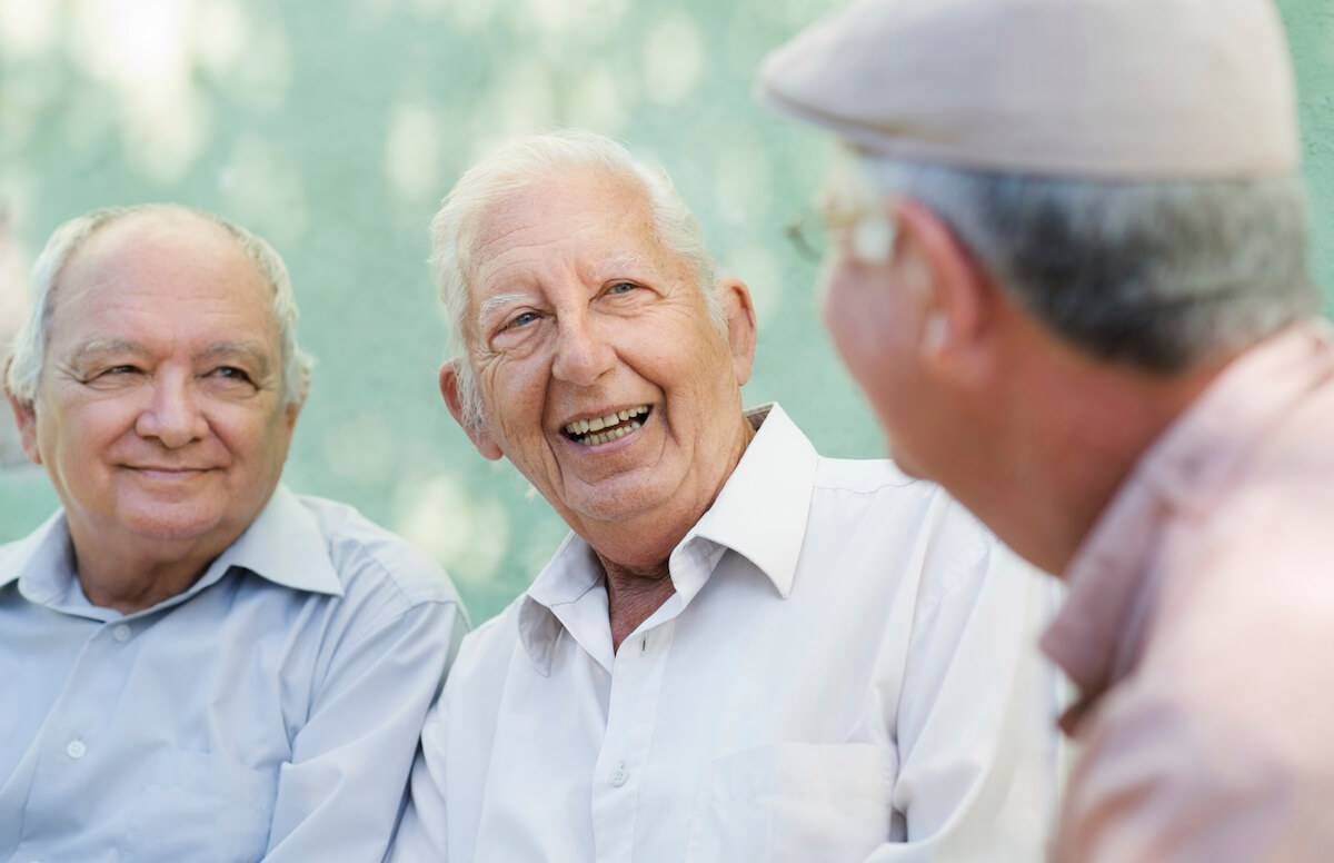 Group of happy elderly men laughing and talking