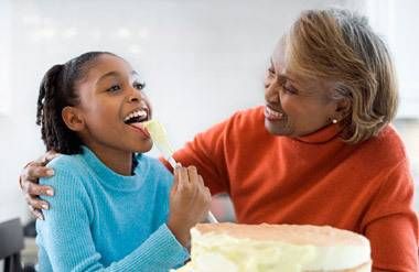 Grandmother and granddaughter making cake