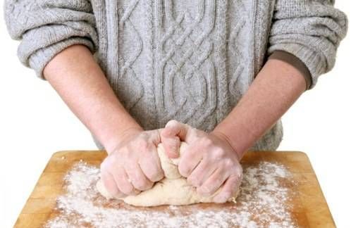 man kneading bread dough