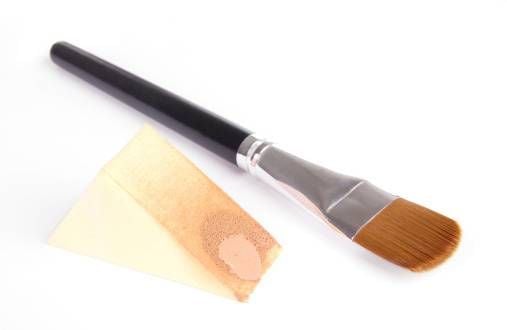 Make-up brush and sponge with foundation