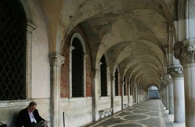 man reading in colonnade