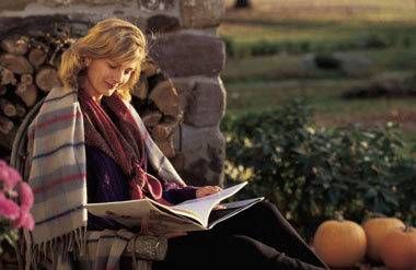 Woman reading a book outside in the Fall