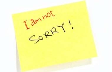 'Sorry' written on post it note with 'i am not' added in red