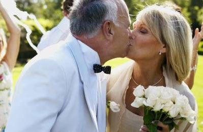 mature bride and groom kissing