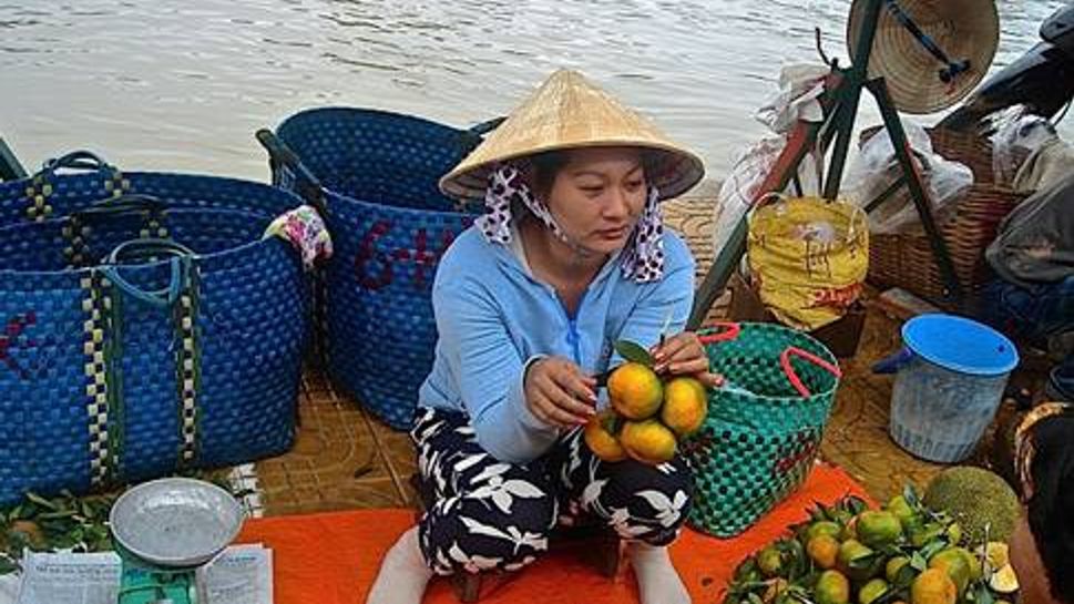 A woman sells a variety of local fruits