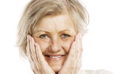 Mature woman holding her face