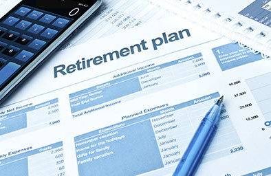 Retirement plan sheet with pen and calculator
