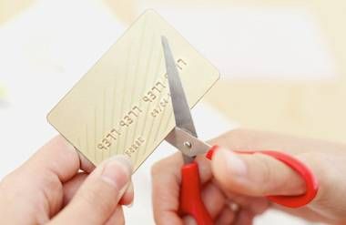 Person cutting up credit card