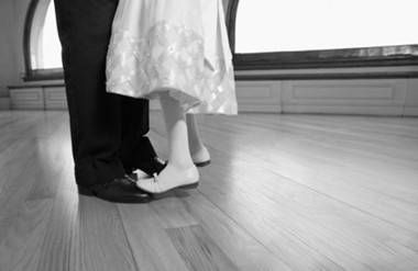 a little girl dancing on her father's toes
