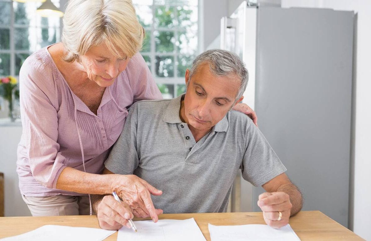 Couple reviewing caregiving paperwork