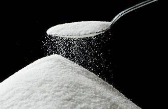 spoon of sugar with a mound below