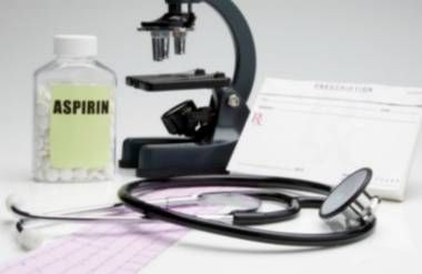 Microscope, stethoscope, prescription pad, EKG printout and aspirin