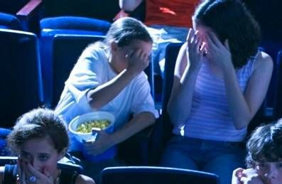 kids covering their eyes at movie theater