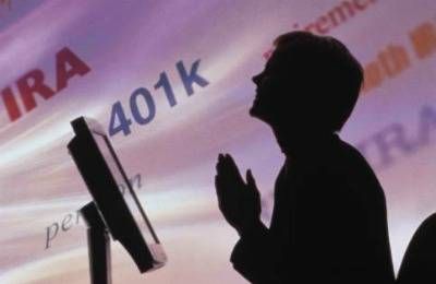 woman at computer praying in front of swirling 401k, IRA 