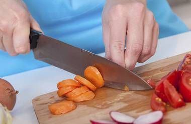 Person preparing food on cutting board