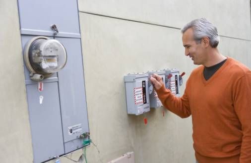 Man checking his home electric meter