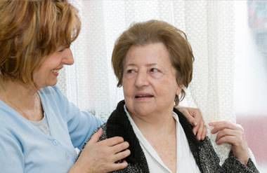 Middle-aged woman talking with her elderly mother.