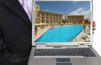 man presenting image of hotel on laptop screen
