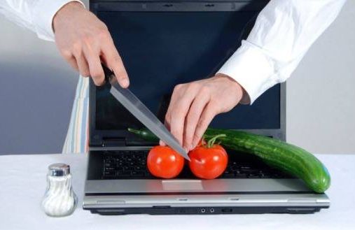close up, man cutting vegetables on laptop