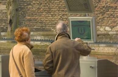 couple using tourist information kiosk