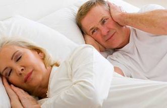 a man awake from his wife's snoring