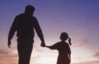 Father and daughter walking together holding hands