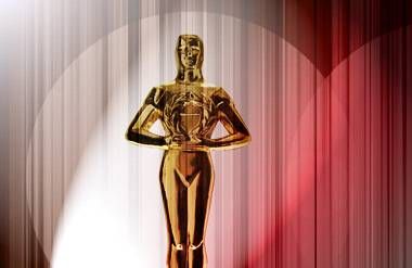 Oscar award with lights and red curtain