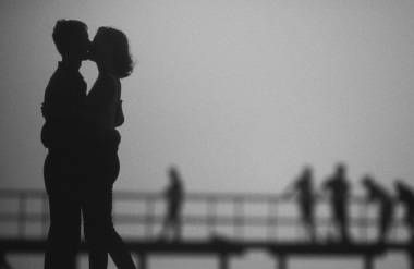 Couple kissing on pier