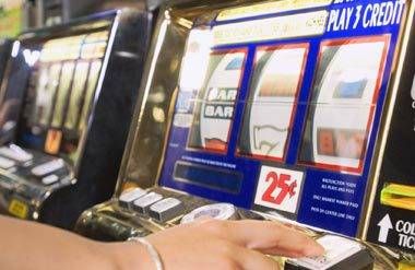 Woman playing slot machine