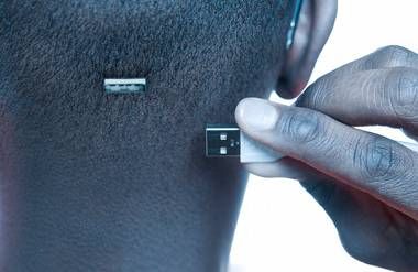 an african american man with a usb drive in the back of his head