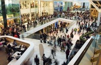 A shopping mall filled with people looking for deals on Black Friday, the day af