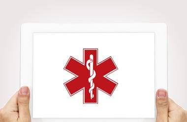 Person holding tablet with caduceus medical symbol