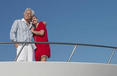 Retired couple standing on yacht