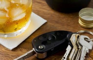 Car keys next to alcoholic drink