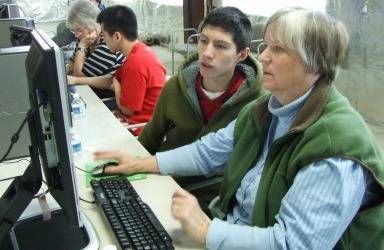 Teens helping seniors learn social networking and internet connectivity