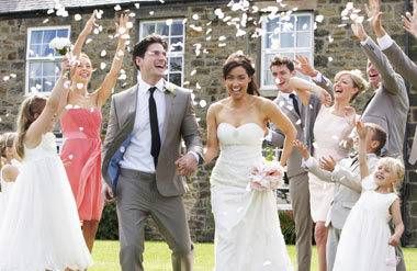 Guests Throwing Confetti Over Bride And Groom