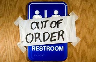 out of order sign taped over a bathroom door