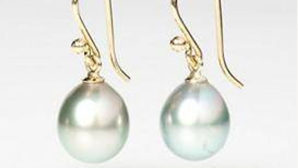white freshwater cultured pearls dangle from handmade 14 karat gold ear wires
