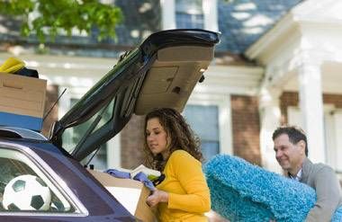 Father helping daughter pack car and move out