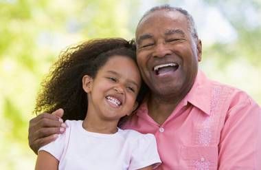 Grandfather and granddaughter laughing