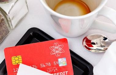 Credit card and bill at cafe